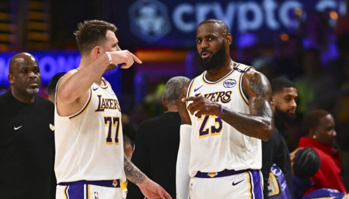 Mar 22, 2025; Los Angeles, California, USA; Los Angeles Lakers guard Luka Doncic (77) and Los Angeles Lakers forward LeBron James (23) on the sidelines against the Chicago Bulls during the first half at Crypto.com Arena. Mandatory Credit: Jonathan Hui-Imagn Images