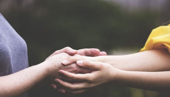 Two-women-holding-each-others-hands-e1619239023805