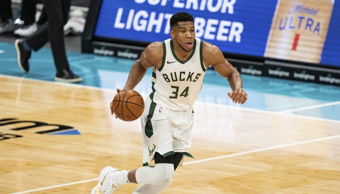 Milwaukee Bucks forward Giannis Antetokounmpo (34) brings the ball up court against the Charlotte Hornets during an NBA basketball game in Charlotte, N.C., Saturday, Jan. 30, 2021. (AP Photo/Jacob Kupferman)