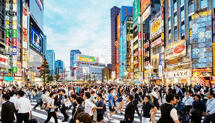 Zebra crossing in Shinjuku, Tokyo at sunset.