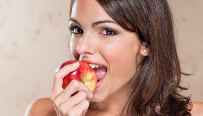 pretty-young-woman-eating-an-apple