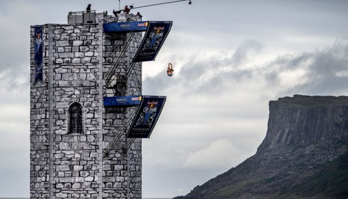 Constantin Popovici of Romania dives from the 27 platform during the final competition day of the fourth stop of the Red Bull Cliff Diving World Series at Ballycastle Harbour, Causeway Coast, Northern Ireland on July 20, 2024. // Dean Treml / Red Bull Content Pool // SI202407200468 // Usage for editorial use only //