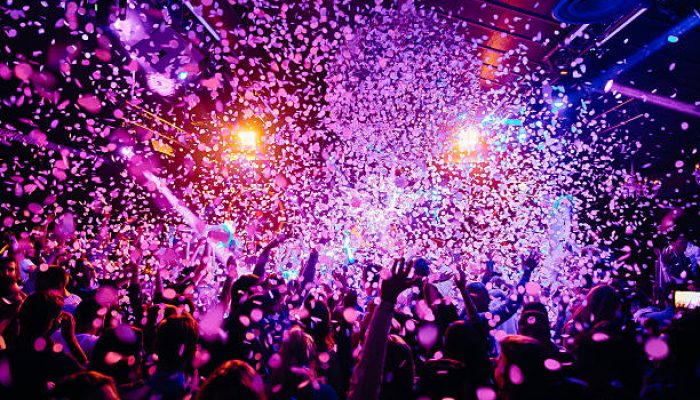 Concert crowd - picture with a lof of people dancing i a concert, night club with raised their hands up! Amazing colours!