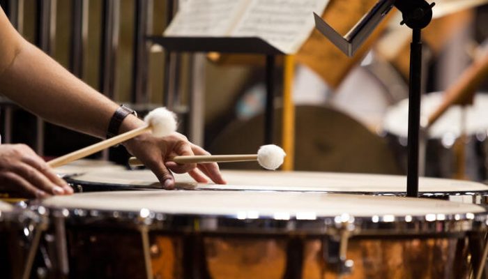 Hands musician playing the timpani in the orchestra closeup